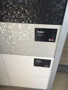 this is an image of a white and black wall with some stickers on it