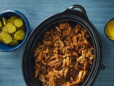 the food in the crock pot is prepared and ready to be eaten with corn on the side