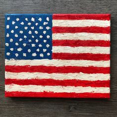 an american flag is painted on a piece of wood