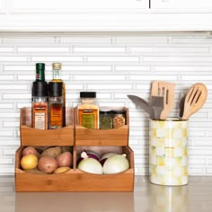 a kitchen counter with spices and utensils in wooden containers next to a white brick wall