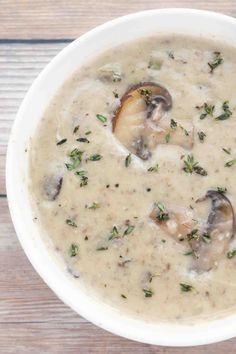 cream of mushroom soup in a white bowl on a wooden table with text overlay