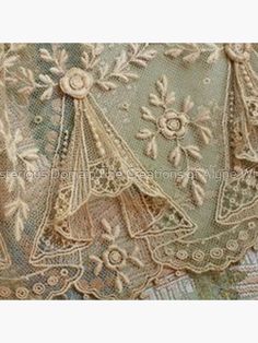 an old lace piece with flowers on it