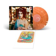 an orange colored vinyl record with the image of a woman in a dress on it