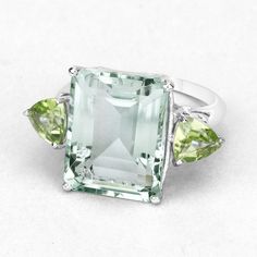 "Prasiolite Ring, Natural Prasiolite and Peridot 3 Stone Ring, Prasiolite Emerald Cut, Sterling Silver Ring, February Birthstone Ring Flaunt yourself with this prasiolite & peridot 3 stone ring. The natural gemstones have a combined weight of 11.90 carats and are set in .925 sterling silver with rhodium plating. The soft green hue of this ring adds a pop of color to any look! The understated design and vibrant stones make this ring perfect for every occasion. Product Details: .925 Sterling S Peridot Three Stone Jewelry As Gift, Three Stone Peridot Jewelry As Gift, Green Amethyst Jewelry With Gemstone Accents, Peridot Three Stone Ring, Three Stone Peridot Ring, Three Stone Peridot Ring Jewelry, Luxury Green Multi-stone Amethyst Ring, Green Sapphire Ring Sterling Silver, May Birthstone, Green Multi-stone Emerald Ring In Sterling Silver