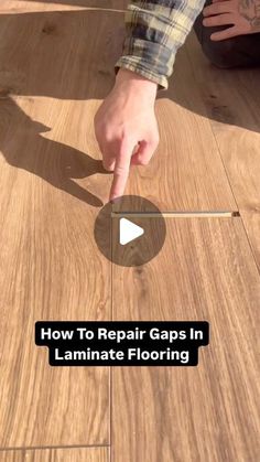 a person pointing to the floor with text overlay that reads how to repair gap in laminate flooring