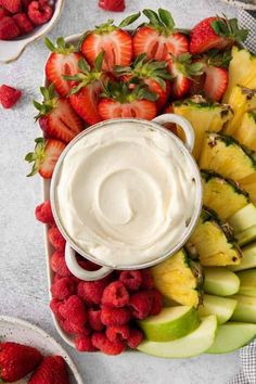 a platter filled with fruit and dip