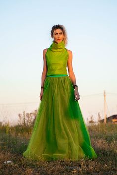 Chic Green Dress With Voluminous Skirt, Green Voluminous Tiered Maxi Skirt, Green Tulle Maxi Skirt For Summer, Summer Green Tulle Maxi Skirt, Chic Voluminous Green Skirt, Chic Green Voluminous Maxi Skirt, Avant-garde Fitted Skirt For Summer, Green Voluminous Maxi Skirt For Spring, Green Dresses With Flowy Skirt