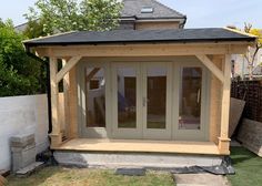 a small wooden building sitting in the middle of a yard