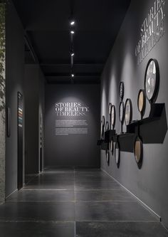 an empty hallway with clocks on the wall