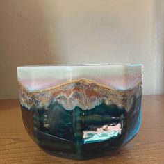 a bowl sitting on top of a wooden table