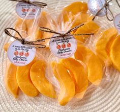 several pieces of fruit are wrapped in plastic bags on a plate with twine string