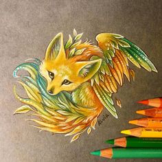 colored pencils are next to a drawing of a fox with wings