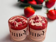 two candles with strawberries on the table