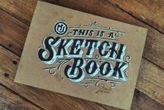 this is a sketch book on a wooden table