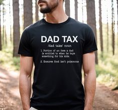 "The \"Dad Tax\" shirt is a perfect funny gift for Father's Day. The shirt is designed with the phrase \"Dad Tax\" and the definition printed on it, which refers to the idea that as a parent, dads are entitled to a portion of their kids' snacks, treats, and meals. The shirt is a hilarious way to celebrate the joy and humor of fatherhood. It is a reminder that dads work hard to take care of their kids, and they deserve a little something in return. So, if you are looking for a fun gift idea for your dad this Father's Day, the \"Dad Tax\" shirt could be the perfect choice! shirt details: This classic unisex jersey short sleeve tee fits like a well-loved favorite. Soft cotton and quality print make users fall in love with it over and over again. These t-shirts have-ribbed knit collars to bols Funny Slogan Shirt For Father's Day, Father's Day Black Shirt With Funny Text, Black Shirt With Funny Text For Father's Day, Funny Text Print Shirt For Father's Day, Custom Text Cotton Shirt For Gift, Funny Cotton Shirt Gift, Funny Cotton Shirt As A Gift, Funny Cotton Shirt As Gift, Funny Shirt For Father's Day Gift