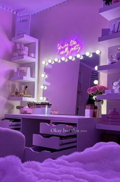 a bedroom with purple lighting and white fur on the bed in front of a mirror