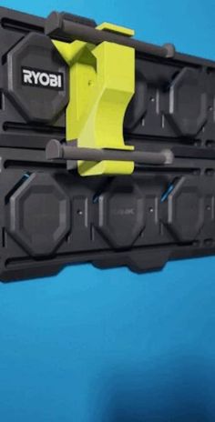 a yellow and black piece of equipment on a blue background