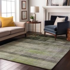 a living room filled with furniture and a rug on top of a hard wood floor