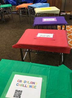 colorful tables with signs on them in a room