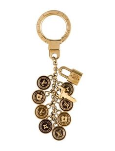 a gold key chain with buttons on it and a metal ring hanging from the end