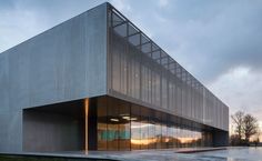 an empty building with glass windows on the outside