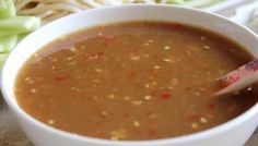 a white bowl filled with soup sitting on top of a table