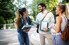 three young people are talking to each other in the park