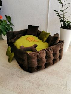 a dog bed that is made to look like an animal's head and tail