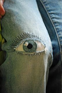 a pair of jeans with an eye drawn on them