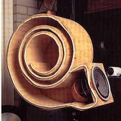 there are speakers stacked on top of each other in this room with wood pieces around them