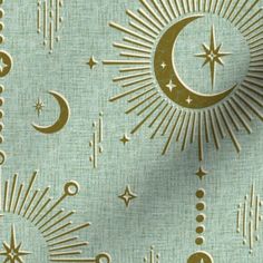 the sun, moon and stars are depicted in gold foil on blue fabric with white background