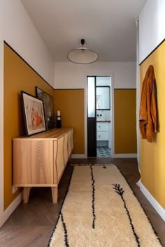 a hallway with yellow walls and white carpet