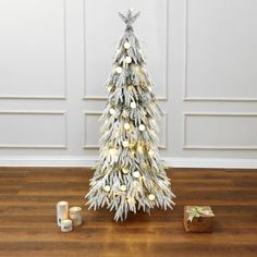 a small white christmas tree with gold ornaments