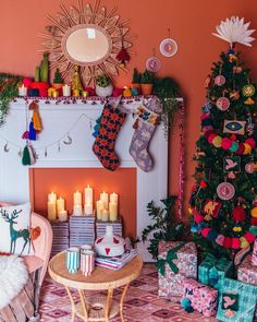 a living room decorated for christmas with candles and decorations on the fireplace mantels