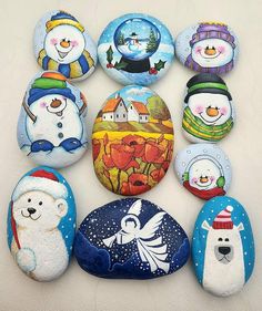 a group of painted rocks sitting on top of a white surface