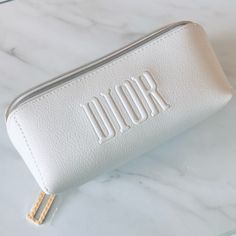 This Is A Dior White Faux Leather Cosmetic Bag. A Beautiful Gift With Purchase (Gwp) From Dior Beauty. Brand New And Unused. No Box. Details: White Faux Leather Exterior Frontal Dior Embossed Logo “D” Charm Zipper Pull Gold Tone Hardware White Plastic-Ky Interior Has Subtle Stars And Cd Logo Designs Measures At Approx. 7”L X 3”H X 3”W. Only Pouch Is Included; No Other Item Is Included. Perfect For Storing Makeup, Organizing Small Items Or For Traveling. Makeup Bag White, Makeup Organizing, Asthetic Stationery, Monogrammed Makeup Bags, Storing Makeup, Dior Cosmetics, Butterfly Photography, Leather Cosmetic Bag, Pouch Makeup