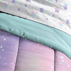 the comforter has stars on it in pastel colors