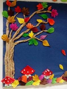 an art project made out of paper and colored umbrellas on a blue background with trees