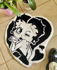 a black and white rug with an image of a woman's face on it