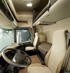 the interior of a bus with beige leather seats