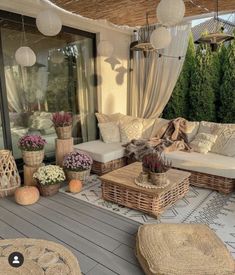 an outdoor living area with wicker furniture