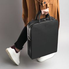 Introducing our Luxury Unisex Laptop Bag-Backpack, the epitome of sophistication and functionality. Meticulously crafted, it seamlessly blends style and practicality for the modern professional.  Features include a padded 16" laptop compartment with reinforced padding, an iPad slip pocket, a pen loop/sunglass holder, and two small pockets for chargers or phones.  Exterior highlights a quick access pocket for tablets, notepads, and a slip pocket for passports or phones.  Wear it cross-body, as a backpack, over the shoulder, or by hand.  Complete with custom-crafted matt black hardware and a custom dustbag, it ensures unparalleled elegance on the go. Material Exterior: 100% European Genuine Leather, small pebbled grain finish  Material Interior: Durable micro suede lining, each collection ha Tote Leather Bag, Bag Interior, Mac Book, Laptop Briefcase, Body Features, Laptop Tote, Sunglass Holder, Bag Luxury, Gifts For New Mums