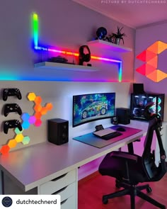 a computer desk topped with a monitor and two gaming headset on top of it