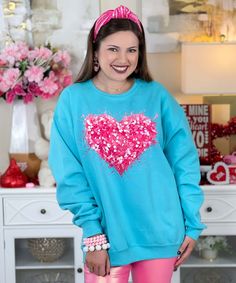 Introducing our Faux Sequin Pink Heart Graphic Shirt, a dazzling and stylish choice for the season of love and Valentine's Day! This graphic tee features a charming heart design adorned with faux sequins, providing the appearance of real sequins without the physical texture or shine.
Celebrate the romantic spirit of Valentine's Day with this eye-catching tee that combines the allure of sequins with the comfort of a graphic design. The faux sequins add a touch of glamour to your outfit, making it Sequin Pink, Season Of Love, Heart Graphic, Valentine Shirt, Outfit Making, Valentines Shirt, Graphic Shirt, Heart Design, Pink Heart