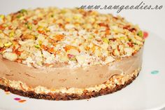 a chocolate cake with nuts on top sitting on a white plate