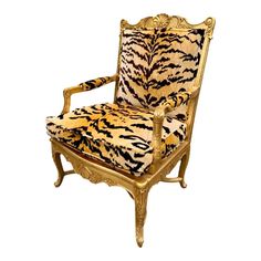 a tiger print chair sitting on top of a white floor