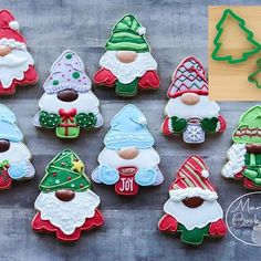 decorated christmas cookies are arranged on a table