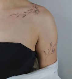 a woman with a flower tattoo on her shoulder