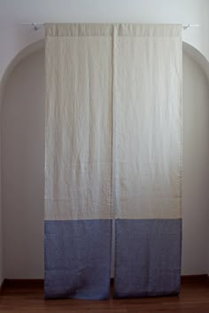 two white and blue curtains hanging on a wall