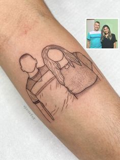 a man's arm with a drawing of a woman holding a baby on it